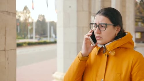 Young Adult Woman Talking on Phone in City
