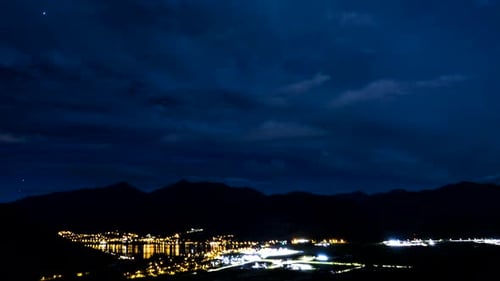 Time-lapse of Clouds Over City at Night