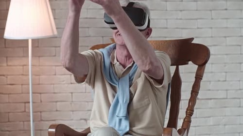 Senior Man Using VR Headset in Rocking Chair