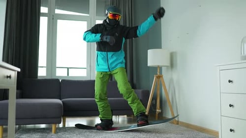 Person in Snowboard Gear Dancing Indoors