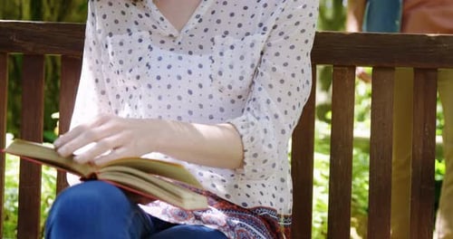 Beautiful woman reading book in park