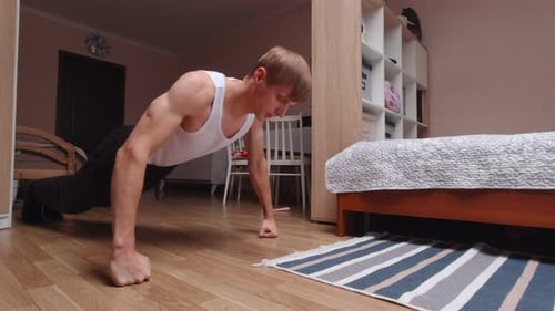Muscular Man Doing Push Ups in Bedroom