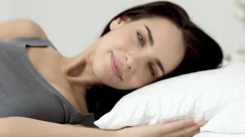 Woman Resting Peacefully in Bed, Close Up