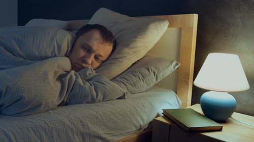 Man Lying in Bed at Night