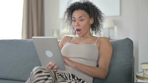 African Woman Reacting to Failure on Tablet at Home