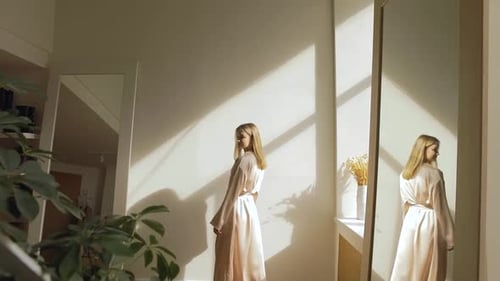 Woman in Robe Posing in Airy Room