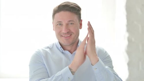 Man Smiling and Clapping