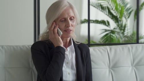 Senior Woman Talking on Phone Indoors