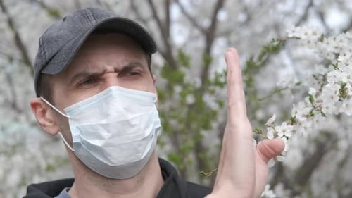 Adult Wearing Mask Outdoors During Spring Flower Bloom