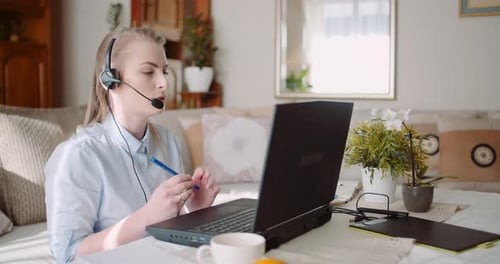 Woman in Headset Talks During Video Call