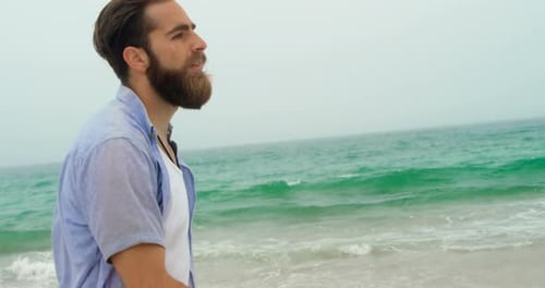 Front view of Caucasian man walking on the beach 4k