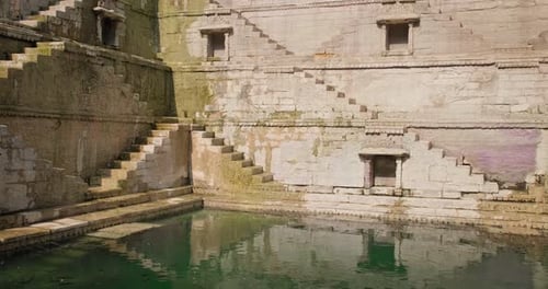 Ancient Stepwell with Intricate Stone Architecture and Water