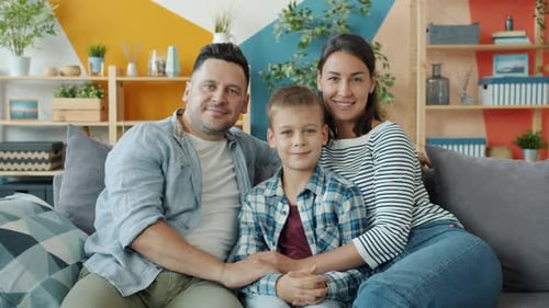 Loving Family Posing on Couch in Home Interior