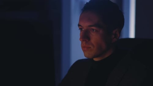 Young Businessman Man Working at Laptop Computer Late at Night