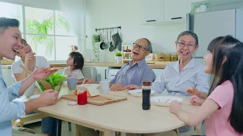 Multigenerational Family Enjoying Meal Together in Kitchen