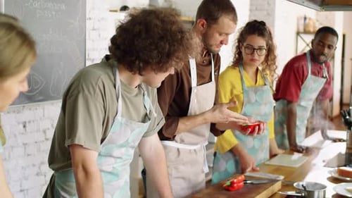 People Learning to Cook Together in Kitchen Classroom