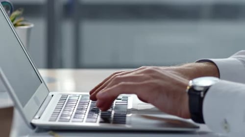 Typing on Laptop Keyboard in Office Environment