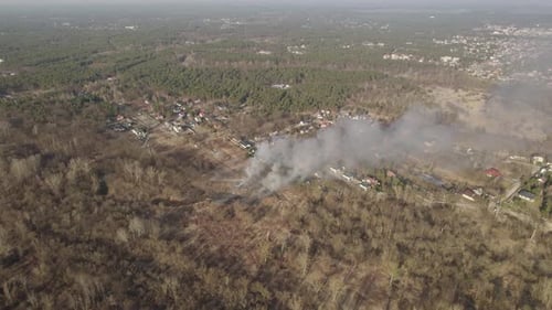 Aerial wide orbit over the wildfire in the suburban area due to the long-lasting drought