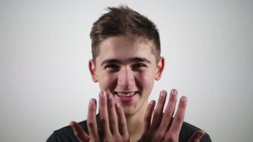 Close Up of a Smiling Young Man Looking at the Camera Isolated on a White Background. Portrait of a