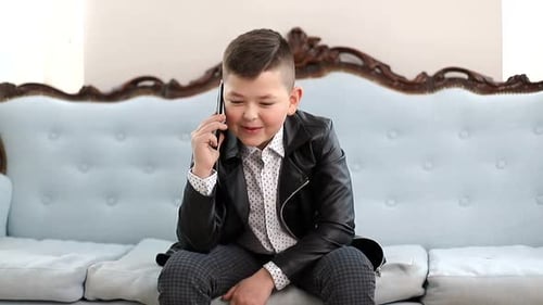 Stylish Boy Talking on Cell Phone on Couch