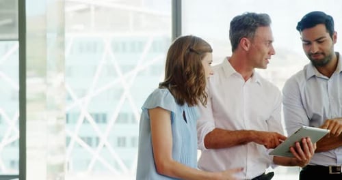 Business people working together on digital tablet in a modern office
