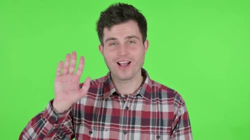 Portrait of Young Man Waving Welcoming Green Chroma Screen