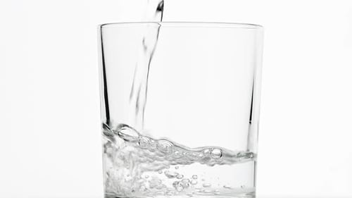 Water Pouring Into Clear Glass Studio Shot