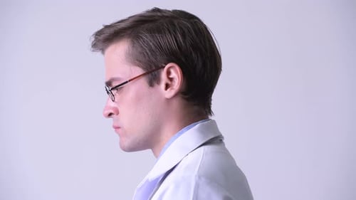 Profile View of Young Handsome Man Doctor Looking Up