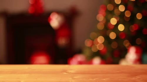 Empty table against blinking lights on christmas tree