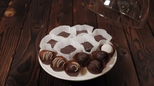 Assorted Chocolates Elegantly Displayed on Wooden Surface