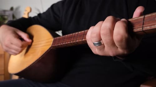 Man Playing Stringed Saz Instrument Close Up