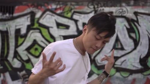 Asian Young Man Dancing Breakdance in the Street