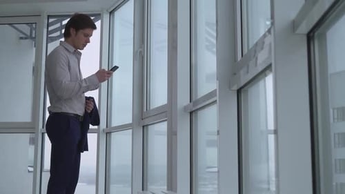 Young Adult Man Using Smartphone in Office
