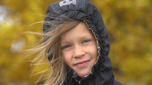Windy Day for Blonde Girl in Hooded Jacket