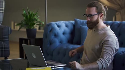 Bearded Man on Laptop During Video Conference