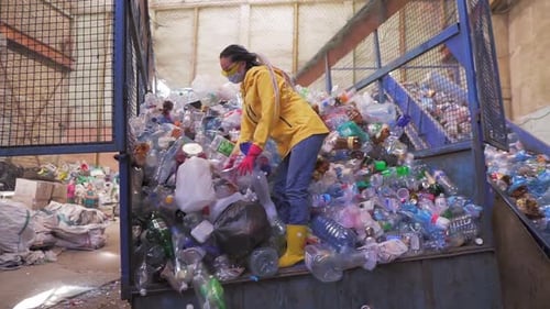 Woman Sorting Plastic Bottles in Recycling Plant