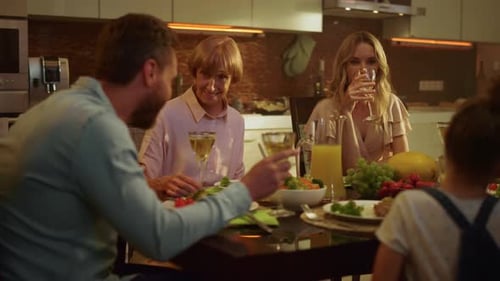 Family Enjoys Meal Together at Dining Table