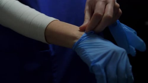 Female Doctor or Nurse Wearing Medical Gloves