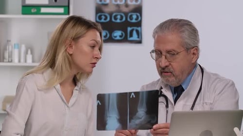 Doctor Consults Patient By Showing Her Picture of Leg and Discusses Treatment of Disease with Her