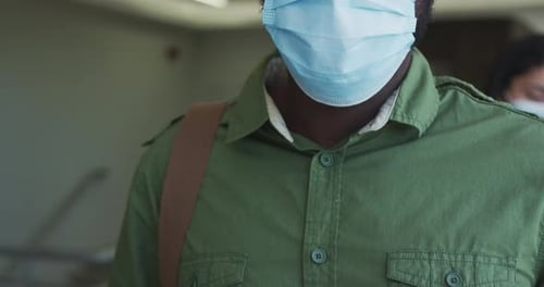 Adult Man Having Temperature Checked with Surgical Mask