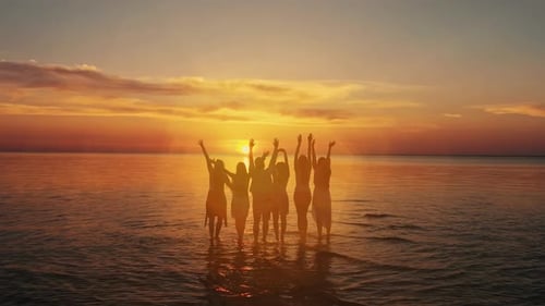 Beach vacations concept. Beauty and joyful teenager friends having fun, dancing, spraying over summe