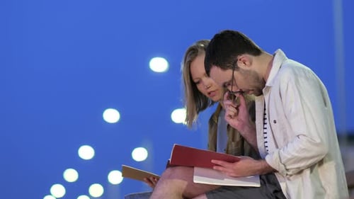 Students Couple Study Outdoors Reading Notes.