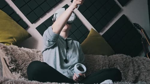 Woman Using Virtual Reality Headset on Couch