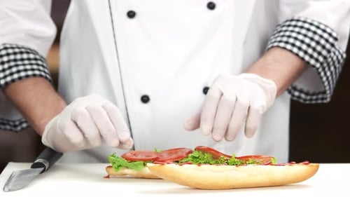 Chef Prepares a Delicious Sandwich with Fresh Vegetables