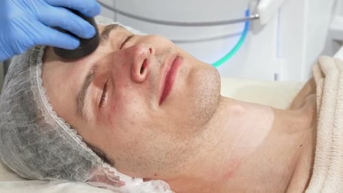 Young Adult Man Receiving Facial Treatment