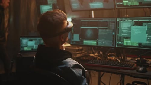 Young Man Uses VR Technology in Dark Room