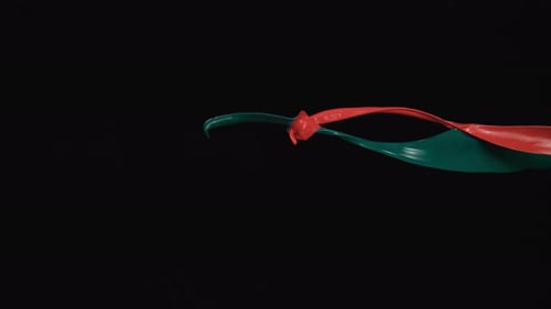 Slow Motion Streams of Red and Green Paint