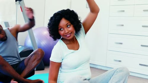 Couple exercising together at home