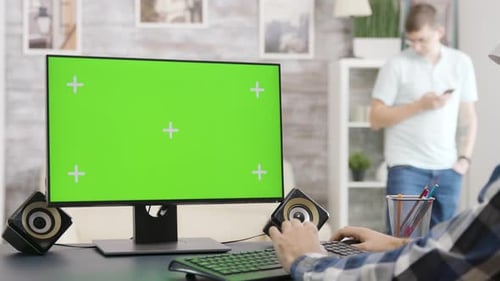 Parallax Zoom in Shot of Man Looking at Green Screen Isolated Mock-up PC Display