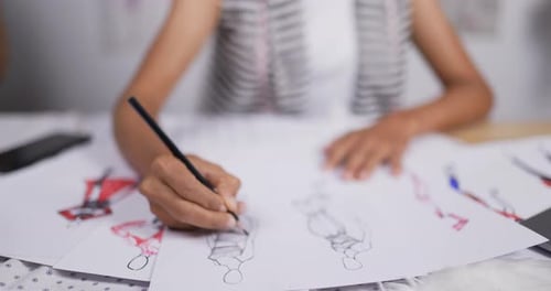 Close up hand of Fashion designer woman draws a sketch of women's clothing